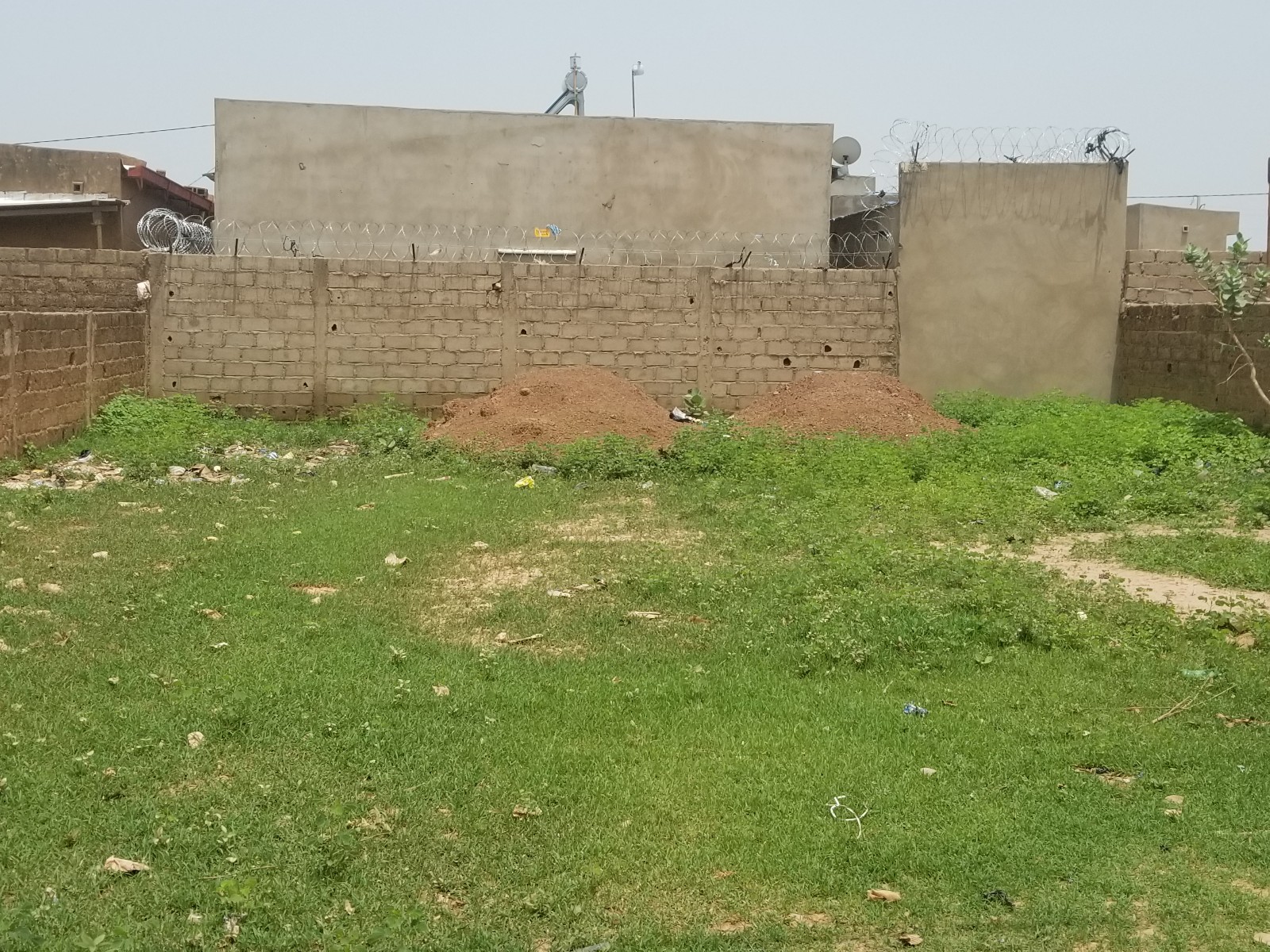 A secured, walled lot owned by Haven Harbor Heritage within the city limits in Burkina Faso, intended for supply storage and logistics