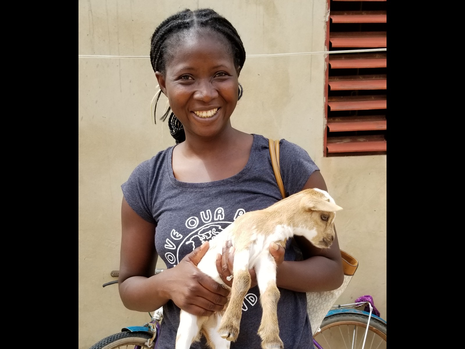 Therese holding a village baby goat in Burkina Faso